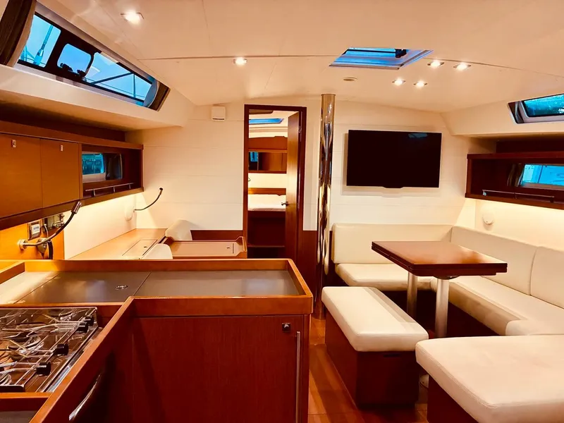 Slide: The Image of Luxurious interior of 2017 Beneteau Oceanis 45 yacht with modern kitchen and seating area. - 22