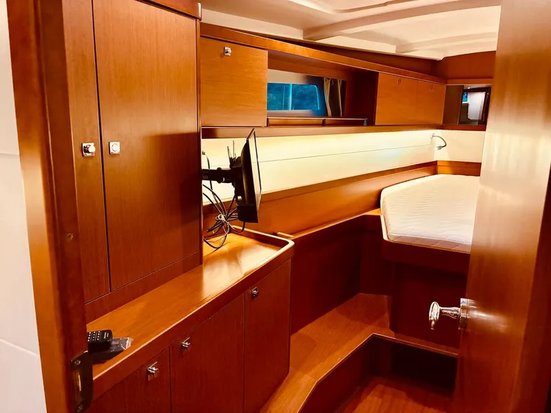 Slide: The Image of 2017 Beneteau Oceanis 45 interior cabin with wood finish and cozy bed. - 24