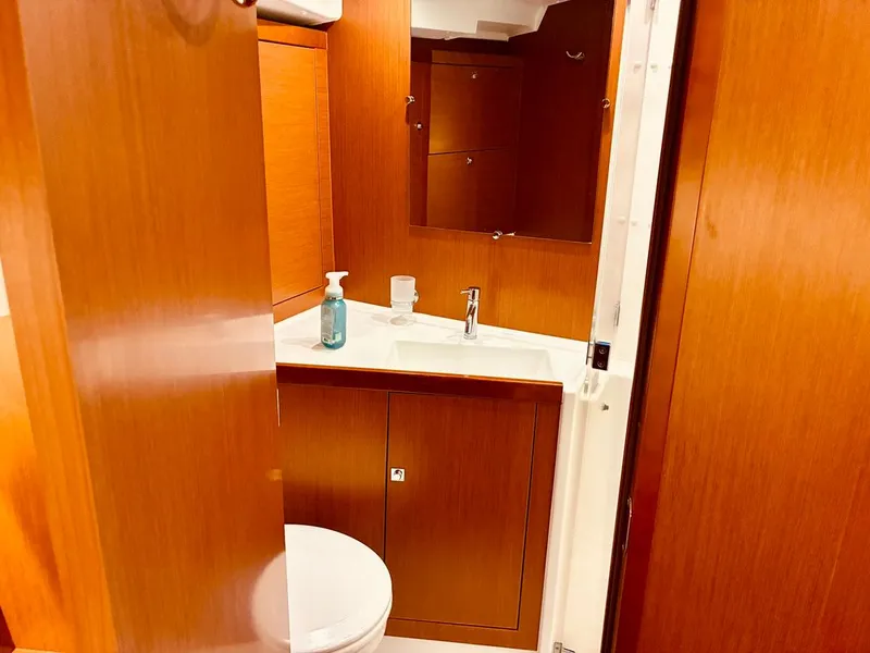 Slide: The Image of Interior of 2017 Beneteau Oceanis 45 yacht bathroom with wooden cabinetry and sink. - 27