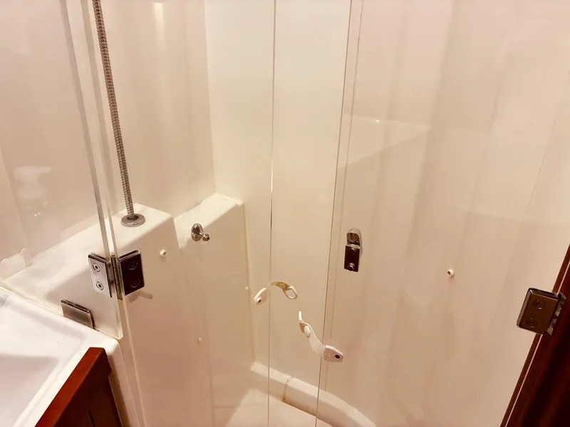 Slide: The Image of Shower area in 2017 Beneteau Oceanis 45 yacht, featuring glass doors and modern fixtures. - 29