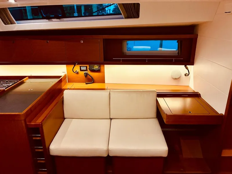 Slide: The Image of Interior of 2017 Beneteau Oceanis 45 yacht with cozy seating and wooden cabinetry. - 31