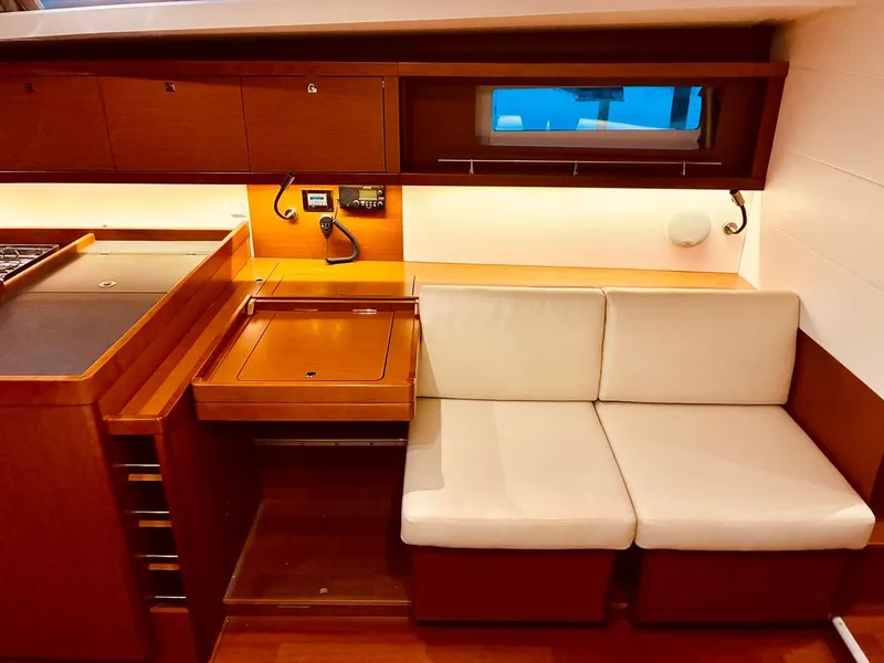 Slide: The Image of Interior of 2017 Beneteau Oceanis 45 yacht with wooden cabinetry and white seating. - 32