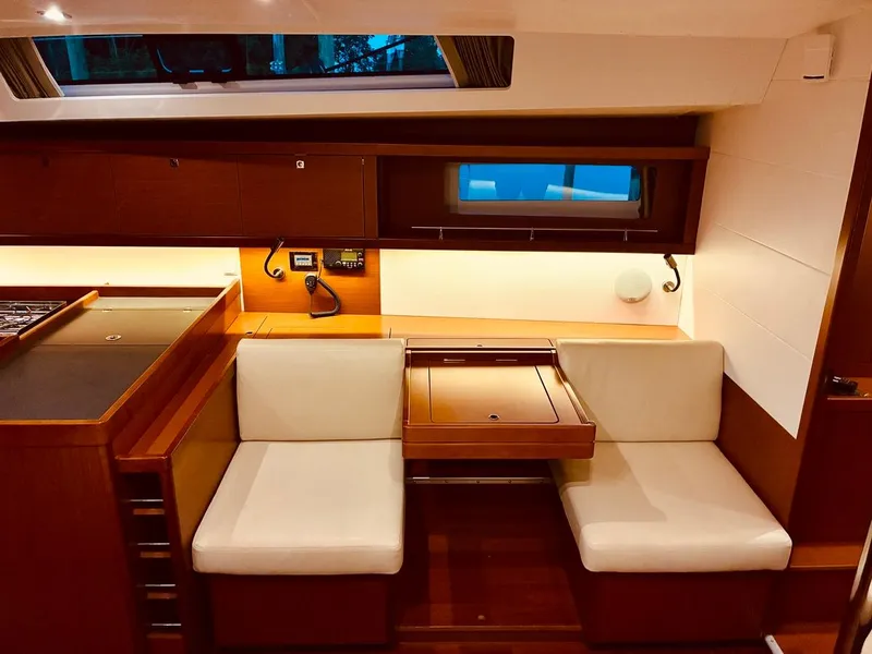 Slide: The Image of Interior of 2017 Beneteau Oceanis 45 yacht with cozy seating and wooden finishes. - 33
