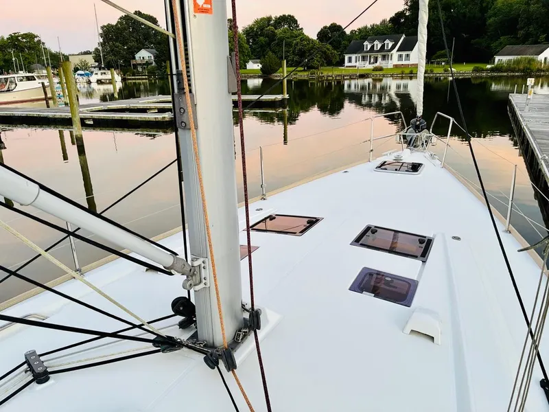 Slide: The Image of Beneteau Oceanis 45 sailboat docked in a serene marina, 2017 model. - 4