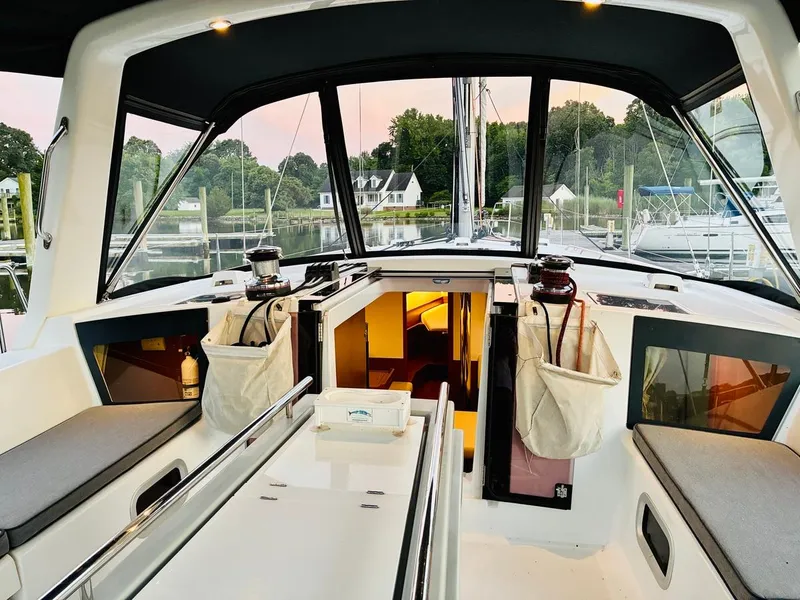 Slide: The Image of 2017 Beneteau Oceanis 45 yacht cockpit with seating, winches, and cabin entrance at marina. - 9