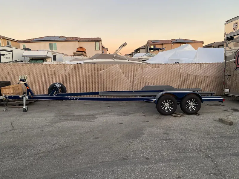 Slide: The Image of 2020 Chris-Craft 25 Launch GT trailer parked in a residential area. - 12