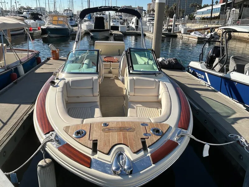 Slide: The Image of 2020 Chris-Craft 25 Launch GT boat docked in a marina. - 2