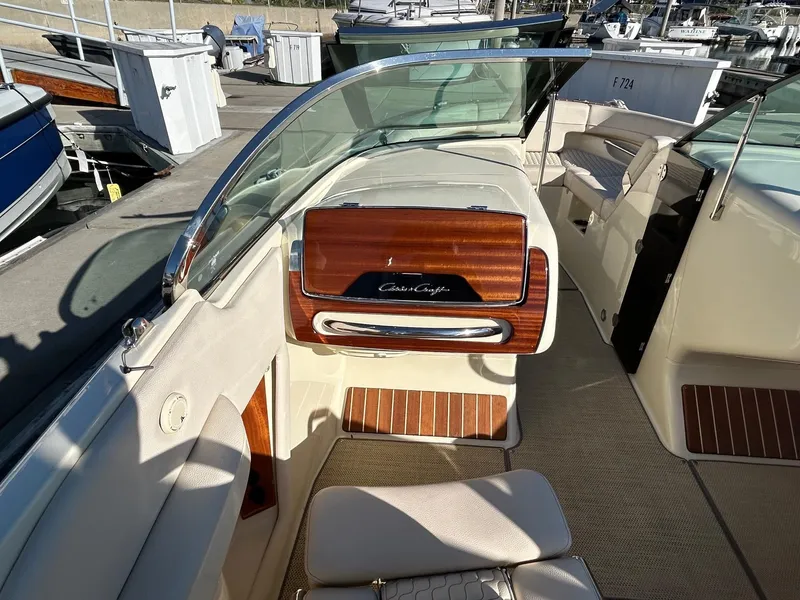 Slide: The Image of 2020 Chris-Craft 25 Launch GT boat interior with elegant wood accents and seating. - 3