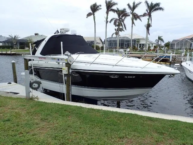 Slide: The Image of 2007 Formula 34 PC boat docked by waterfront homes with palm trees. - 0