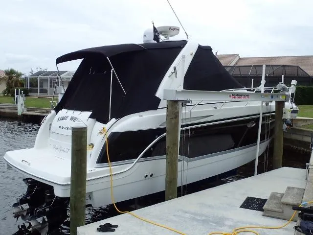Slide: The Image of 2007 Formula 34 PC boat docked with black canopy in marina. - 1