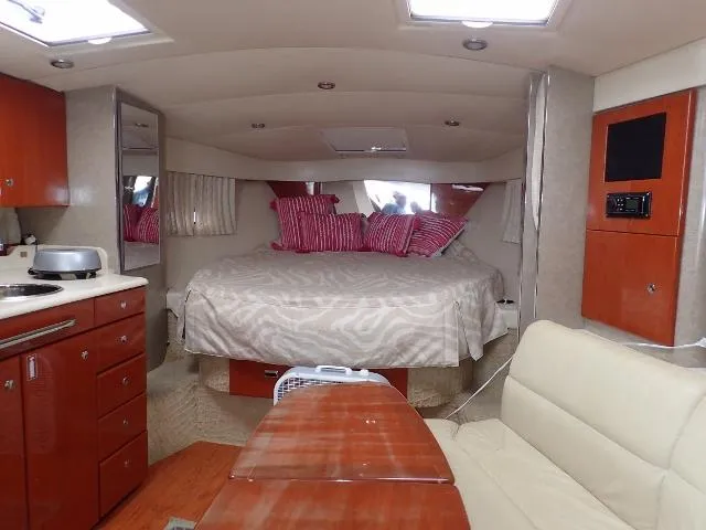 Slide: The Image of 2007 Formula 34 PC yacht interior with bed, kitchenette, and seating area. - 17
