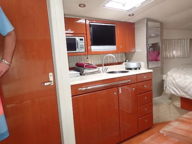 Slide: The Image of 2007 Formula 34 PC yacht interior with kitchenette and cozy sleeping area. - 18