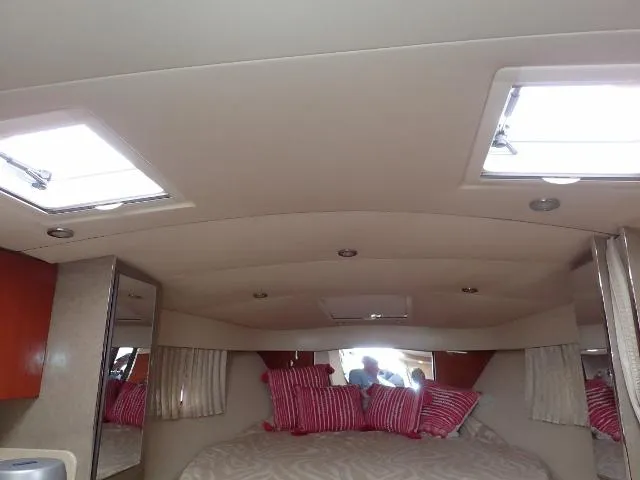Slide: The Image of Interior cabin of 2007 Formula 34 PC yacht with skylights and striped pillows. - 25