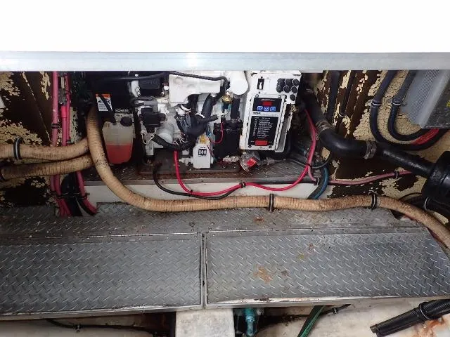 Slide: The Image of Engine compartment of a 2007 Formula 34 PC boat with visible wiring and hoses. - 32