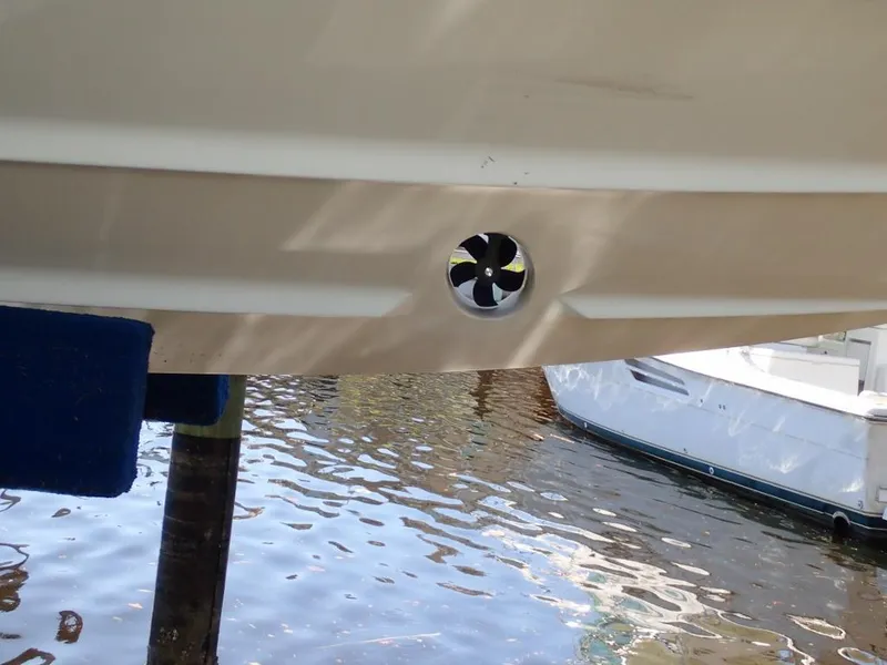 Slide: The Image of 2007 Formula 34 PC boat hull with visible thruster in marina setting. - 42