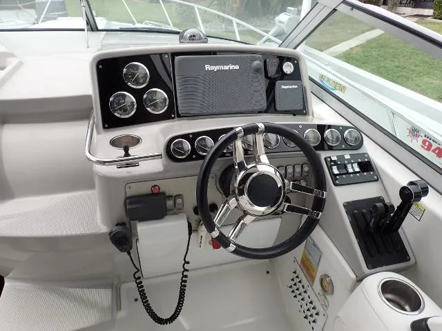 Slide: The Image of 2007 Formula 34 PC boat dashboard with Raymarine navigation system and steering wheel. - 6