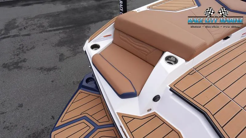 Slide: The Image of 2025 Nautique Super Air Nautique G25 boat with tan seating and teak flooring. - 13
