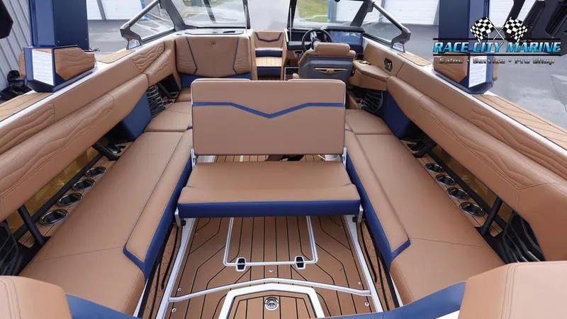 Slide: The Image of 2025 Nautique Super Air Nautique G25 interior with luxurious tan and blue seating. - 22