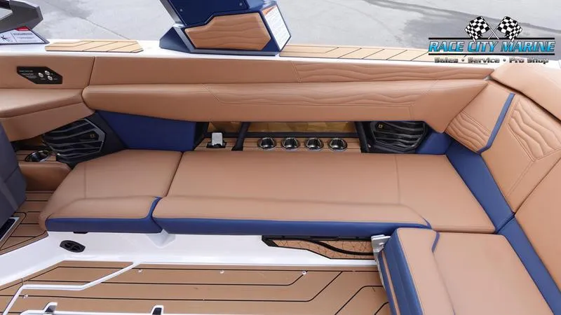 Slide: The Image of 2025 Nautique Super Air Nautique G25 interior with tan and blue seating. - 23