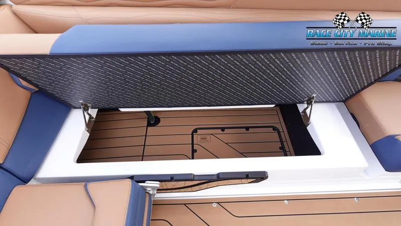 Slide: The Image of 2025 Nautique Super Air Nautique G25 storage compartment with open lid, showcasing interior space. - 25