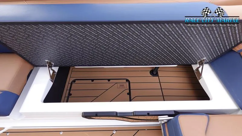 Slide: The Image of 2025 Nautique Super Air Nautique G25 storage compartment with open lid, showcasing interior design. - 26