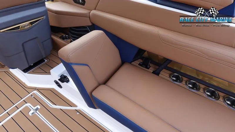 Slide: The Image of 2025 Nautique Super Air Nautique G25 interior with tan seating and wood flooring. - 27