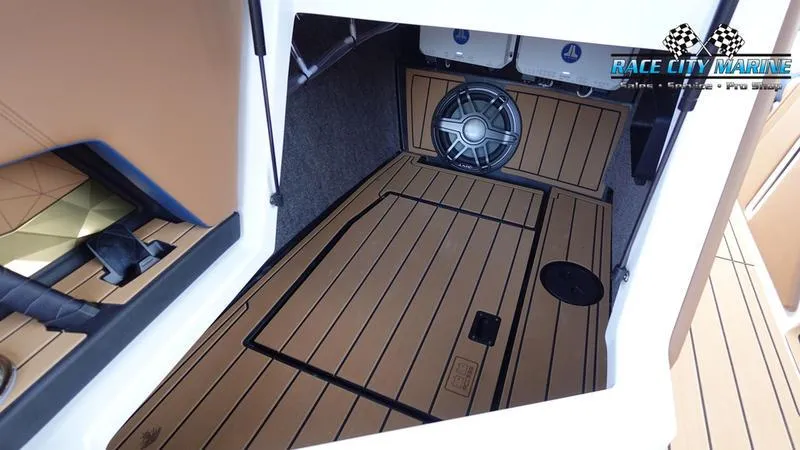Slide: The Image of 2025 Nautique Super Air Nautique G25 interior with teak flooring and speaker system. - 30