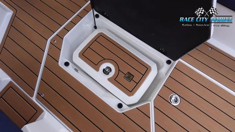 Slide: The Image of 2025 Nautique Super Air Nautique G25 boat deck with storage compartment. - 32