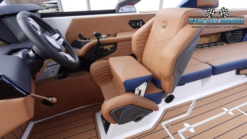 Slide: The Image of 2025 Nautique Super Air Nautique G25 interior with tan leather seats and modern dashboard. - 33