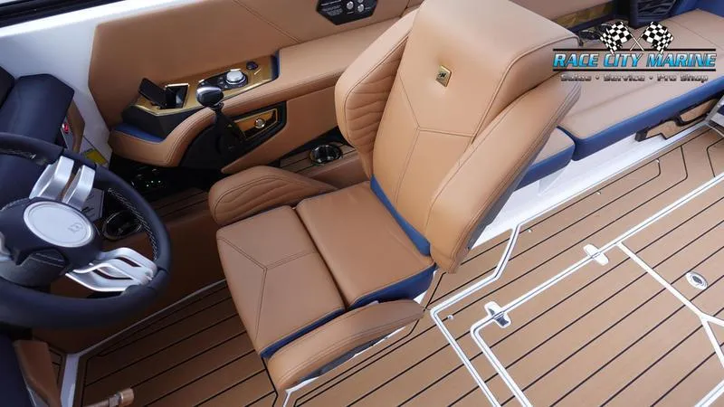 Slide: The Image of 2025 Nautique Super Air Nautique G25 interior with tan leather seating and modern controls. - 34