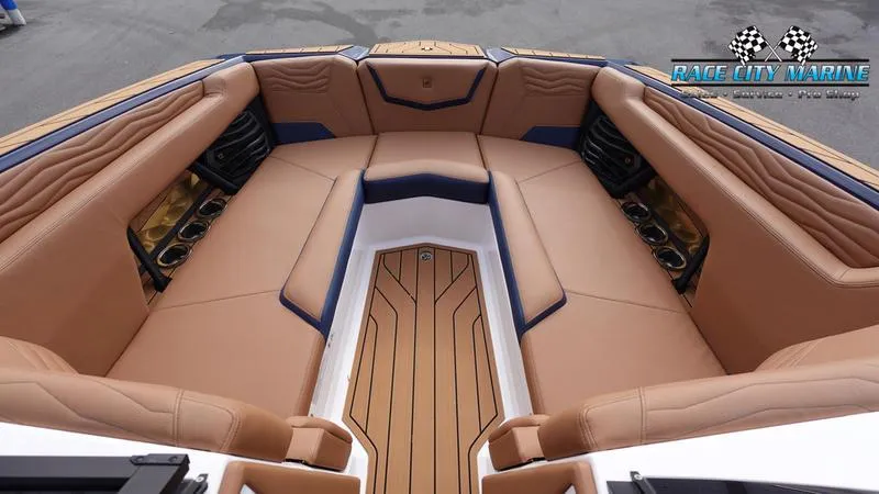 Slide: The Image of Luxurious interior of 2025 Nautique Super Air Nautique G25 boat with tan seating. - 47