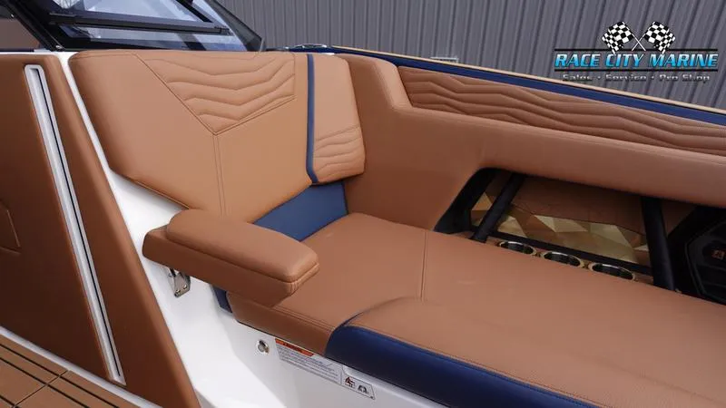 Slide: The Image of 2025 Nautique Super Air Nautique G25 interior with tan and blue seating. - 49