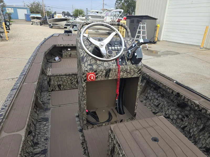 Slide: The Image of 2025 Pro-Drive 2054 X Series boat interior with camouflage design and steering console. - 14