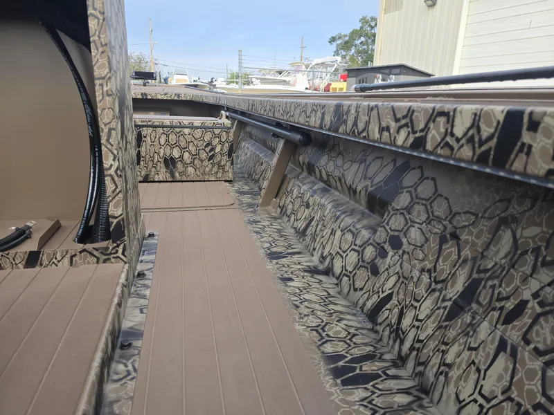 Slide: The Image of 2025 Pro-Drive 2054 X Series boat interior with camouflage pattern and spacious deck. - 17