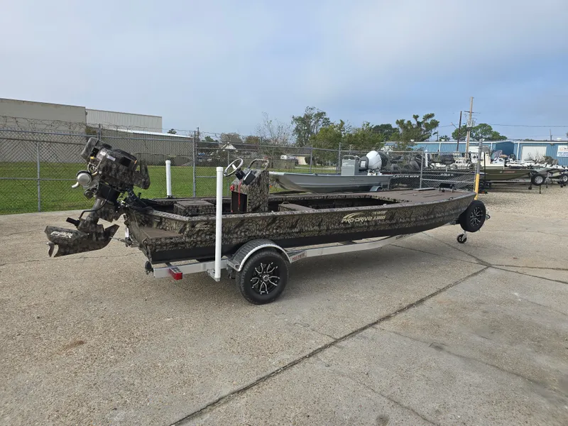 Slide: The Image of 2025 Pro-Drive 2054 X Series boat on trailer, parked outdoors. - 2