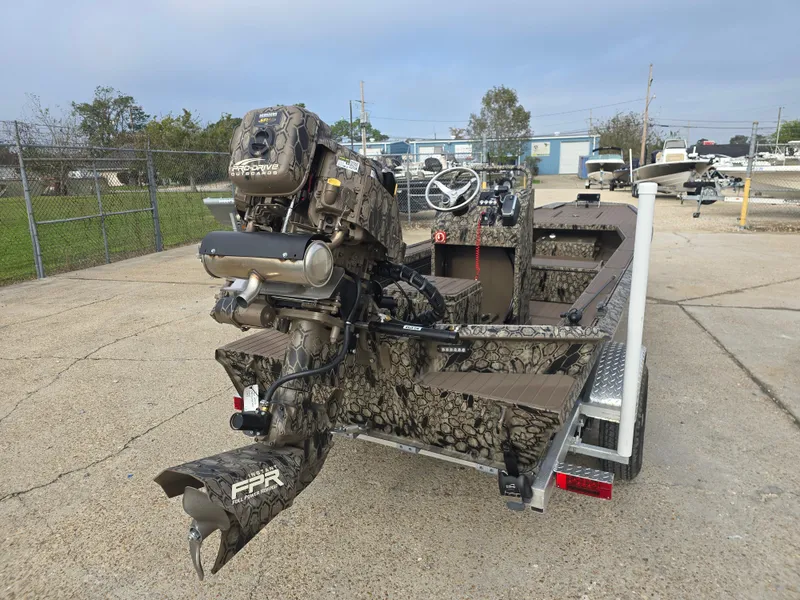 Slide: The Image of 2025 Pro-Drive 2054 X Series boat with camo design on a trailer. - 3