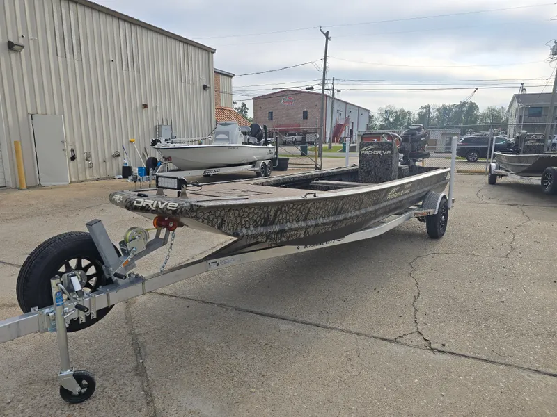 Slide: The Image of 2025 Pro-Drive 2054 X Series boat on trailer in industrial setting. - 7