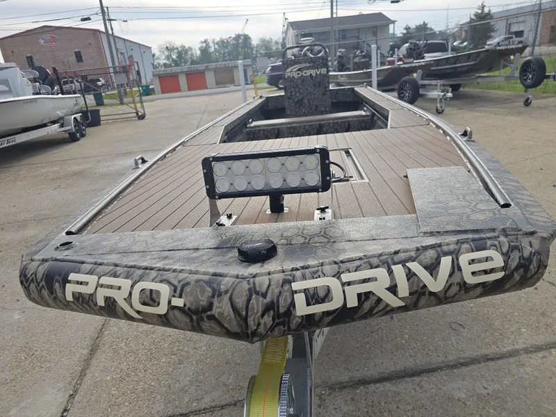 Slide: The Image of 2025 Pro-Drive 2054 X Series boat with camouflage design and LED light. - 8