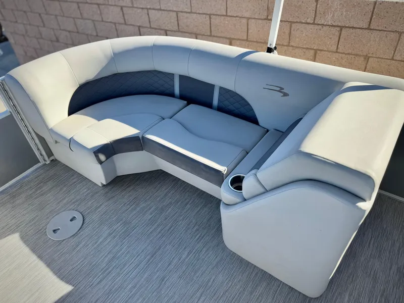 Slide: The Image of 2021 Bennington 23 LSR boat interior with gray cushioned seating and cup holder. - 16