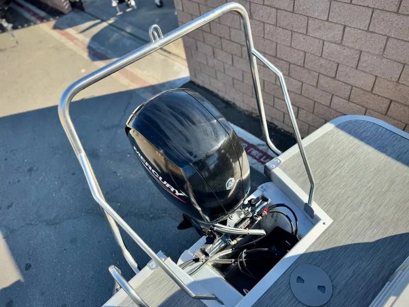 Slide: The Image of 2021 Bennington 23 LSR boat with Mercury outboard motor, docked near brick wall. - 17