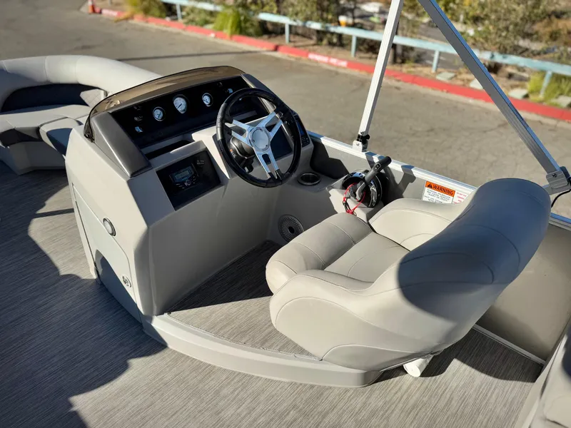 Slide: The Image of 2021 Bennington 23 LSR boat interior with steering wheel and captain's chair. - 19