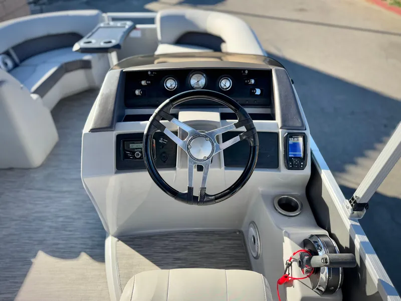Slide: The Image of 2021 Bennington 23 LSR boat interior with steering wheel and dashboard. - 20