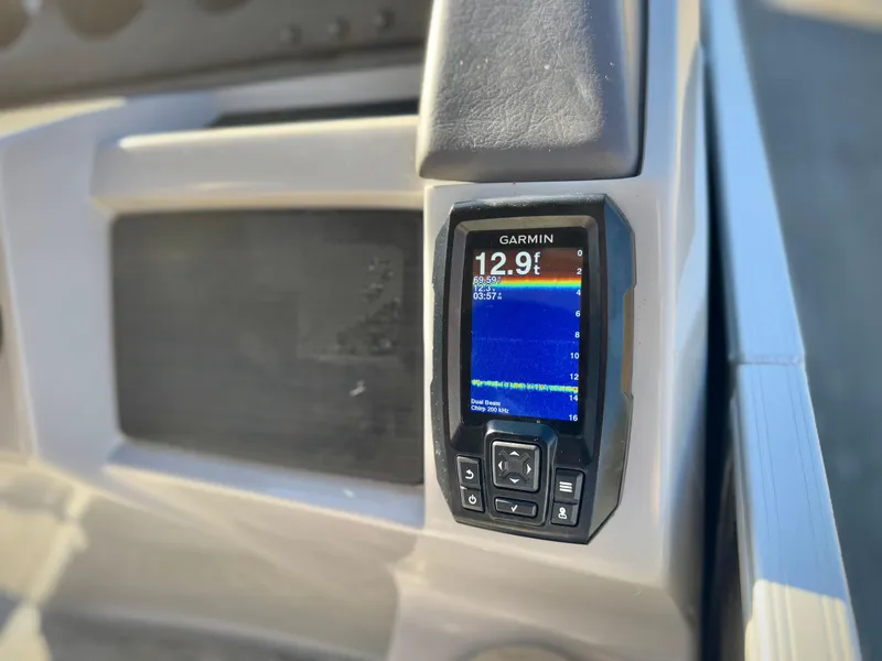 Slide: The Image of Garmin device on 2021 Bennington 23 LSR boat dashboard displaying depth reading. - 23