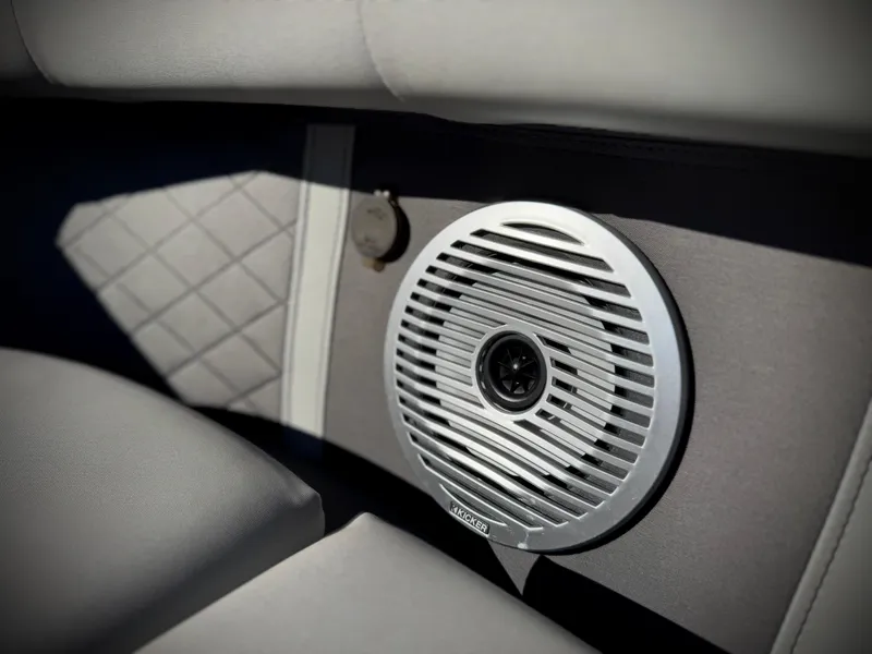 Slide: The Image of 2021 Bennington 23 LSR boat interior with speaker and quilted upholstery. - 24