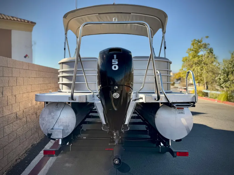Slide: The Image of 2021 Bennington 23 LSR pontoon boat with 150 HP engine, rear view. - 5
