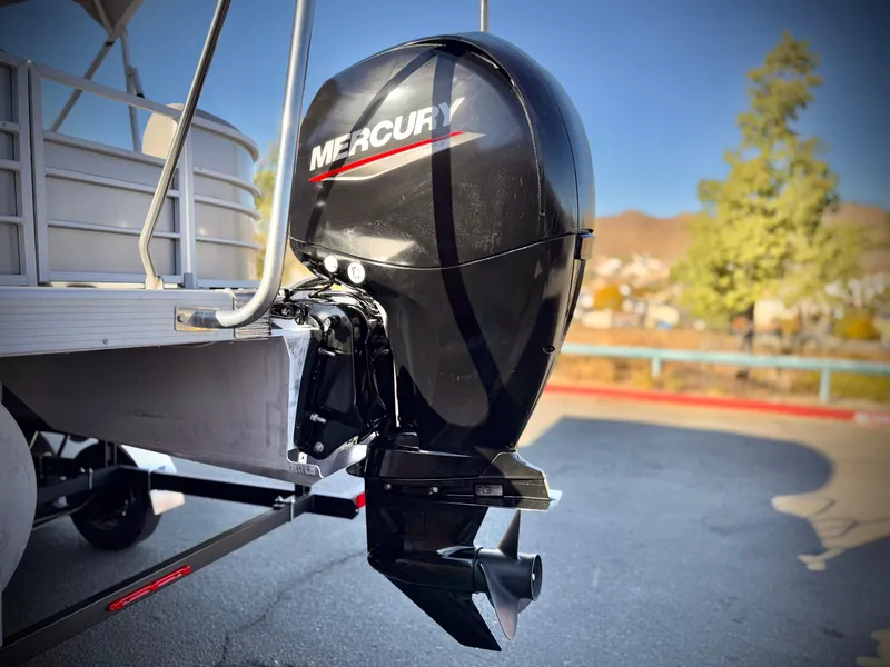 Slide: The Image of 2021 Bennington 23 LSR with Mercury outboard motor in a sunny outdoor setting. - 7