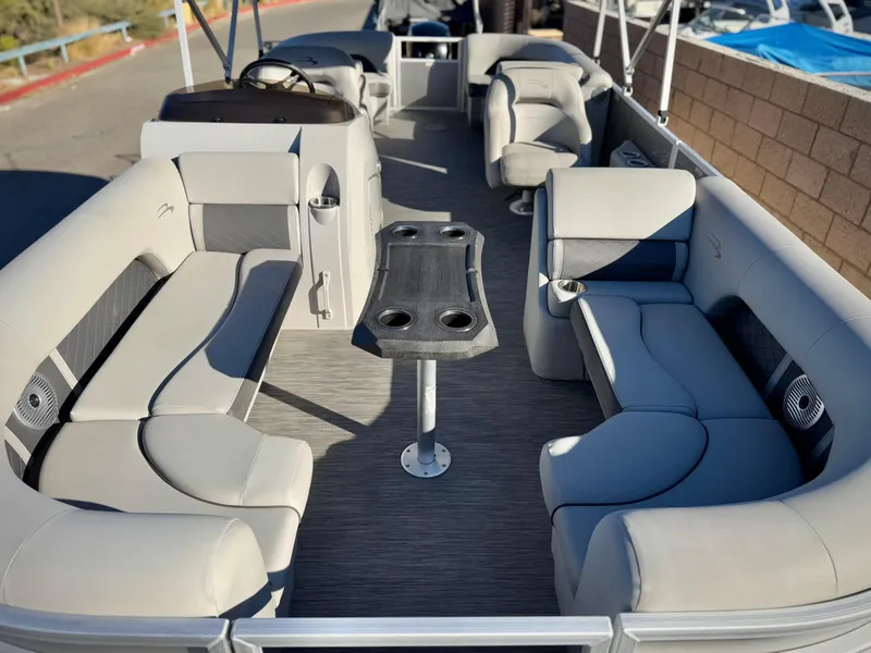 Slide: The Image of 2021 Bennington 23 LSR pontoon boat interior with spacious seating and central table. - 8