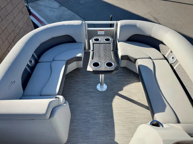 Slide: The Image of 2021 Bennington 23 LSR boat interior with plush seating and cup holders. - 9