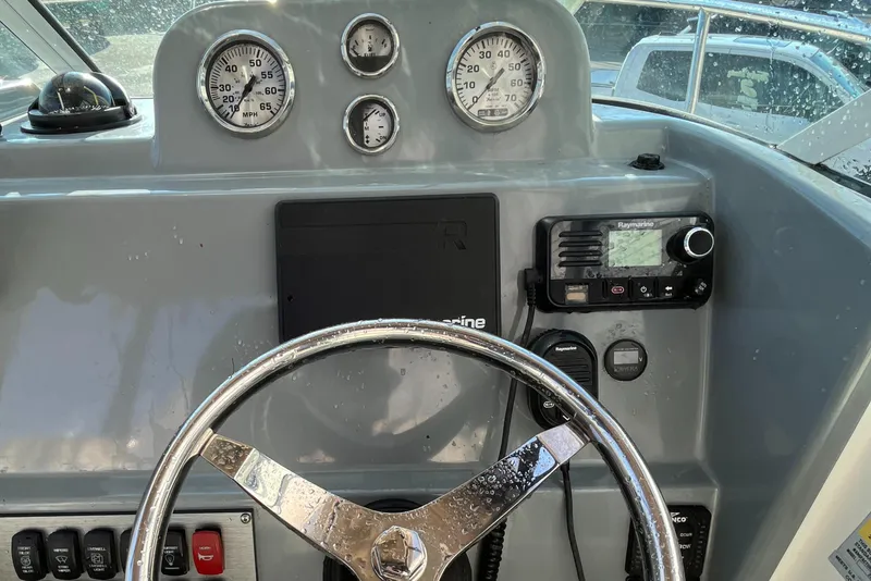 Slide: The Image of 2019 Striper 200 Walkaround boat dashboard with steering wheel and gauges. - 11