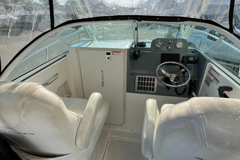 Slide: The Image of 2019 Striper 200 Walkaround boat interior with steering wheel and white seats. - 15